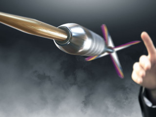 Man throwing dart to an objective