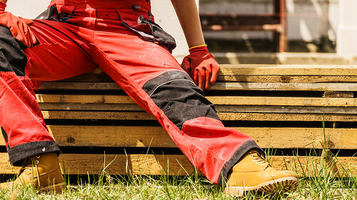 Person wearing red worker trousers