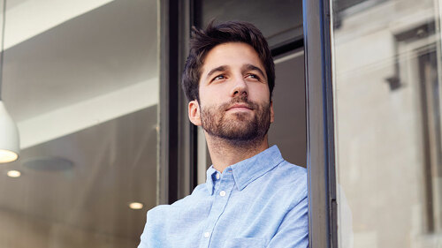 Portrait Of Male Owner Standing Outside Coffee Shop