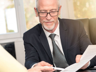 Woman meeting financial adviser in office, light effect