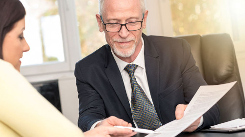 Woman meeting financial adviser in office, light effect