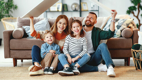 concept housing a young family. mother father and children in new home
