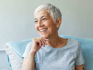 Happy woman relaxing on her couch at home in the sitting room. P