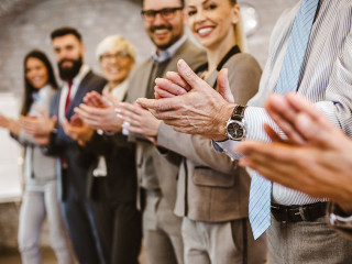 Great job! Successful business team is clapping their hands in m