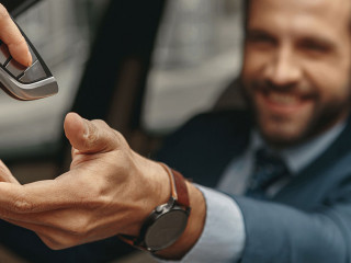 Image of man getting the keys to the automobile from the seller
