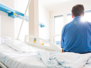 Senior male patient in a modern hospital. Getting better after a