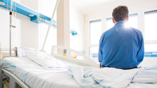 Senior male patient in a modern hospital. Getting better after a