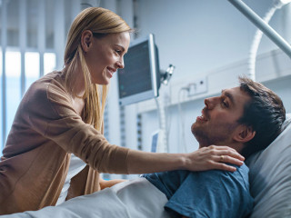 In the Hospital, Happy Wife Visits Her Recovering Husband who is