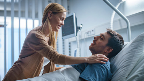 In the Hospital, Happy Wife Visits Her Recovering Husband who is