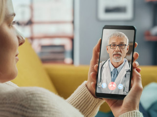Close Up of a Female Chatting in a Video Call with Her Senior Fa