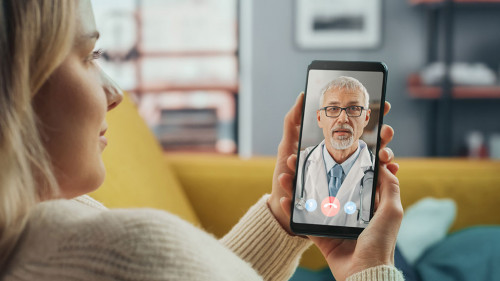 Close Up of a Female Chatting in a Video Call with Her Senior Fa