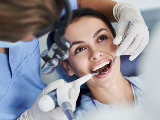 Charming young woman receiving dental treatment at clinic