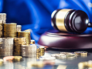 Towers with euro coins flag of European Union and justice hammer in the background