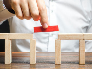 A man is completing the construction of a bridge. Build bridges, make connections and useful contacts. Improving and developing a business. New innovative solutions, growth and prosperity