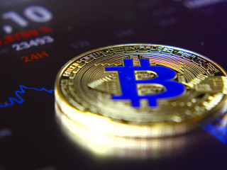 Golden bitcoins on the background of a graphic stock chart. The Concentration of the Crypto-Currency of Virtual Money