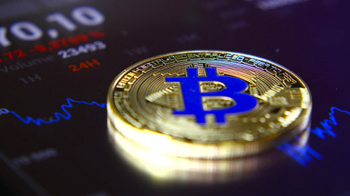 Golden bitcoins on the background of a graphic stock chart. The Concentration of the Crypto-Currency of Virtual Money