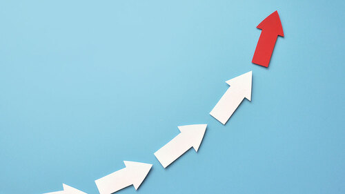 Many white arrows follow one red arrow. Symbol of following the