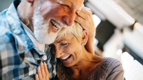 Happy senior couple in love hugging and bonding with true emotions at home