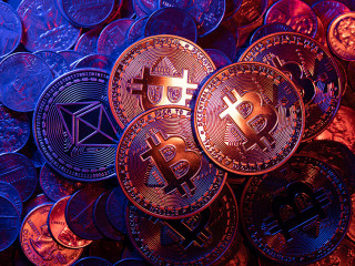 Shiny Bitcoin coins on piled up Ethereum and US Dollar coins