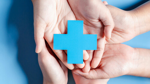 Health insurance concept. Doctor in a white coat uniform hand holding plus and healthcare medical icon, health and access to welfare health concept.