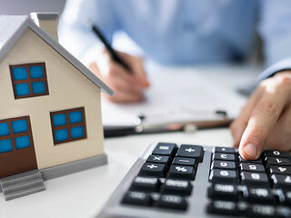 Businessman's Hand Calculating Invoice