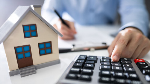 Businessman's Hand Calculating Invoice