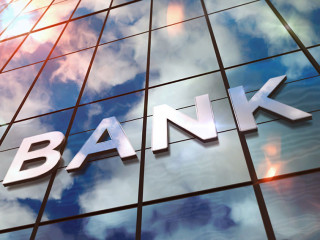 Bank glass skyscraper with mirrored sky