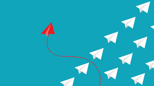 Red paper plane out of line with white paper to change disrupt a