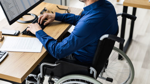 Disabled Handicapped Man In Wheelchair Working