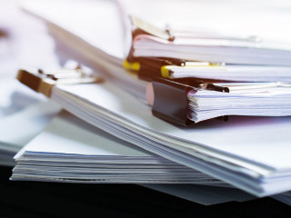 Stack of papers documents in archives files with clip papers on