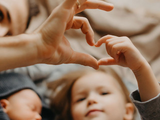 stylish bearded father kisses a sleeping newborn girl. Parent ho