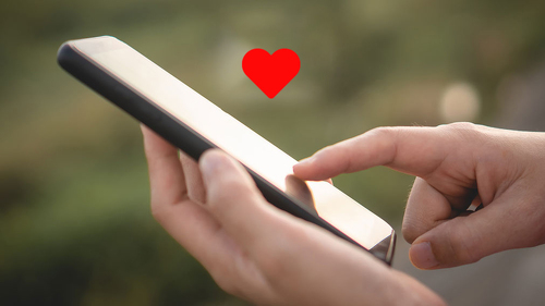 Woman hand use smartphone in public area with 1 new email alert