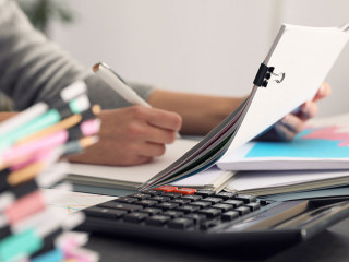 Office employee working with documents at table, closeup
