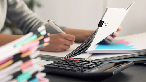 Office employee working with documents at table, closeup