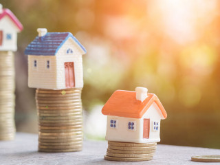 Mini house on stack of coins,Money and house, Real estate invest