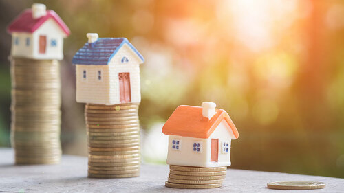 Mini house on stack of coins,Money and house, Real estate invest