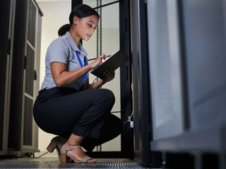 Engineer, server room and woman with tablet for database connection cable, maintenance or software update at night. Cybersecurity, it and female coder with technology for networking in data center.