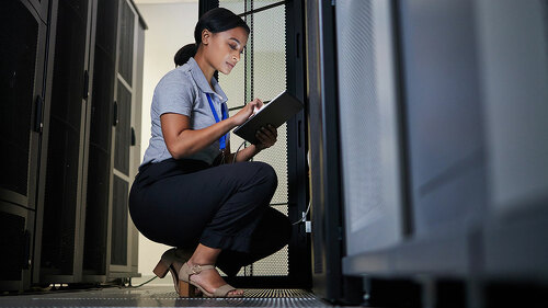 Engineer, server room and woman with tablet for database connection cable, maintenance or software update at night. Cybersecurity, it and female coder with technology for networking in data center.