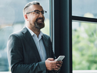 Anzugtraeger-Smartphone-Laecheln-301587384-DP-AndrewLozovyi