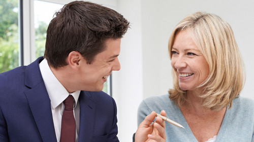 Mature Woman Meeting With Financial Advisor At Home