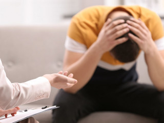 Psychotherapist working with young man in office