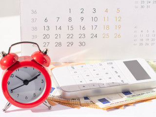 red round alarm clock , calculator, calendar and euro banknoteseuro banknotes. planning concept, business concept