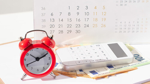 red round alarm clock , calculator, calendar and euro banknoteseuro banknotes. planning concept, business concept