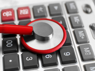 Life insurance concept. Stethoscope and calculator on clipboard