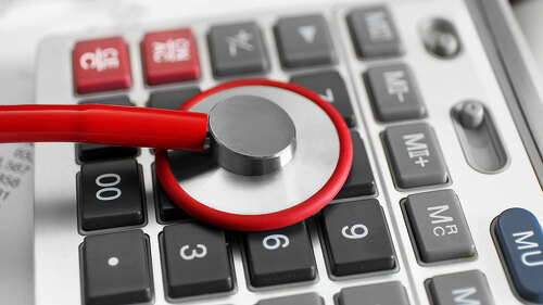 Life insurance concept. Stethoscope and calculator on clipboard