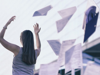 Business woman throwing work papers in the air. Stress from work