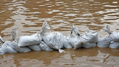 wall of sandbags to fend off raging river
