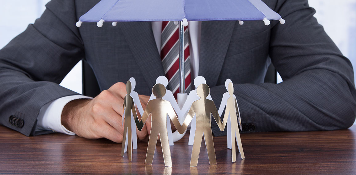 Businessman Sheltering Paper People With Umbrella