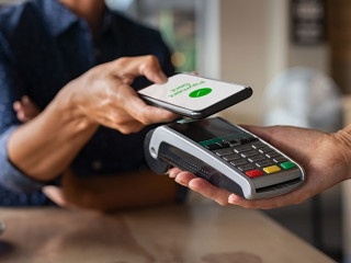 Woman paying using NFC technology