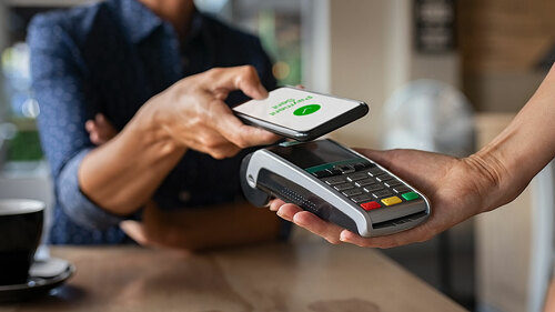 Woman paying using NFC technology